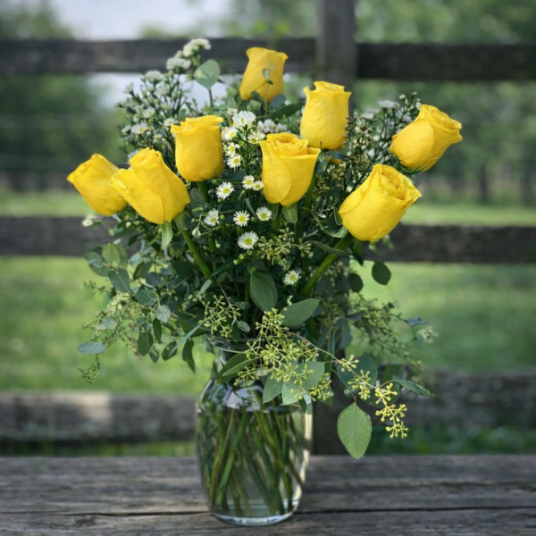 Dozen yellow roses in vase